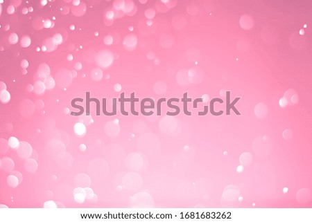 Abstract bokeh lights with light red background
