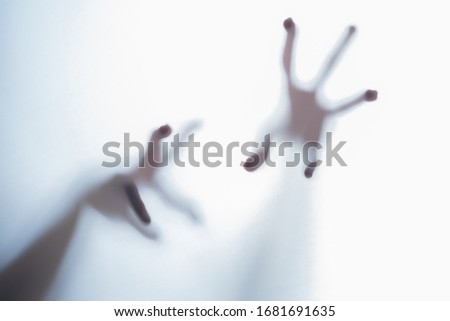 Shadow of blurred creepy fingers from an unknown creature like an alien. 