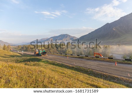 Road constructionin altai, Russia. Misty morning landscape.