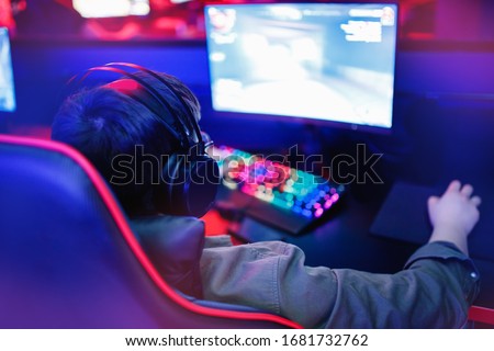 Guy plays computer video games during coronavirus epidemic insulation. Soft focus.
