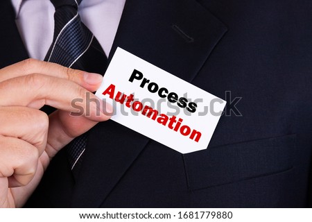 Businessman putting a card with text PROCESS AUTOMATION in the pocket