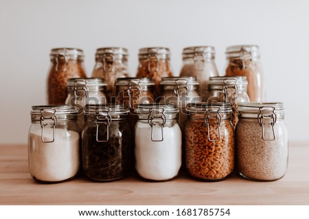 Air tight glass jars filled with rice and pasta and basic ingredients