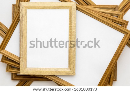 square wooden frames with a white text field on a background from other frames