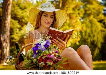 Beautiful girl reading a book in autumn park
