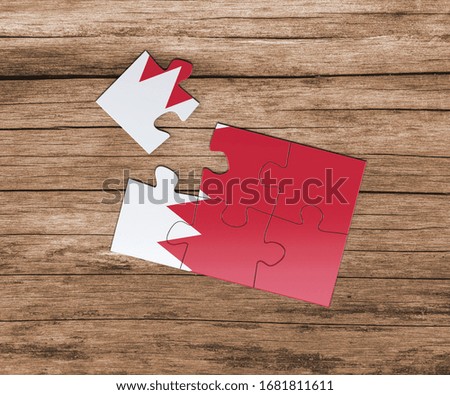 Bahrain national flag on jigsaw puzzle. One piece is missing. Danger concept.