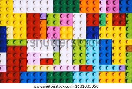 Colored toy bricks close-up. School or preschool creative background. Building kids plastic blocks.