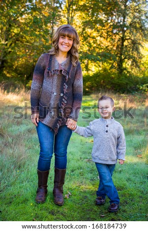 Natural light is used for this portrait of two people including a mother and her son outdoors.