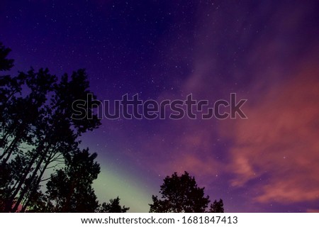 Exposure of the northern lights mixed with the last fading light of the evening