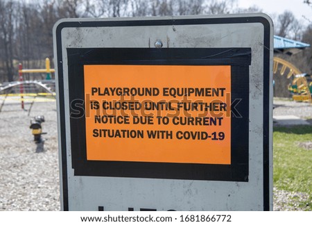 Playground equipment closed due to COVID-19 in local park on sunny day.