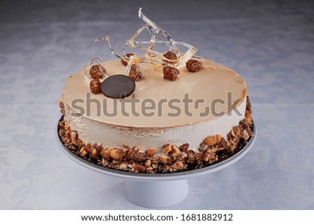High pastry cake for important events with decorations on a stand.