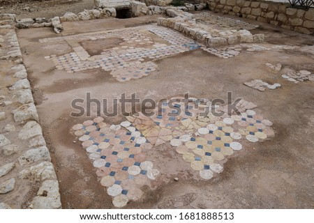 Remains of medieval floor mosaics in fortress Kizkalesi. There are hexagonal  quadrangular forms of decor tiles. Some of them damaged with ages  weather. Picture taken in Kizkalesi, Turkey