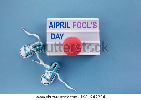 April fool's day. Surprise symbol. Shoelaces tied together on blue wooden background. April fool.