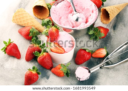 Strawberry ice cream scoop with fresh strawberries and icecream cones on a rustic background Royalty-Free Stock Photo #1681993549