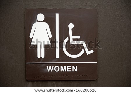 A common, brown, bathroom, faded women's sign.