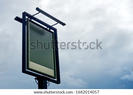 Blank empty Pub Sign against blue sky background. Add your own copy text or brandling to this template                    