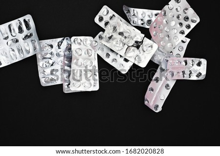 empty packs of pills. Levitation from empty packs from under tablets. place for recording. Black background.