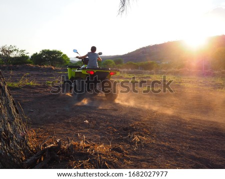 Girl riding quad bike off road in nature