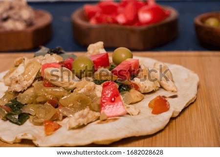Piadina. traditional italian food with tomatoes, onion and chicken