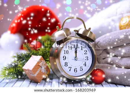 Composition with retro alarm clock and Christmas decoration on bright background
