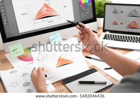 Graphic designer drawing sketches logo design. The concept of a new brand. Professional creative occupation with idea. Royalty-Free Stock Photo #1682046436