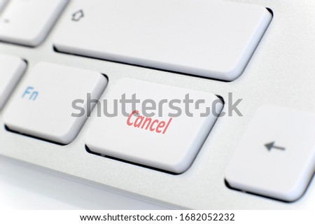 Modern white keyboard with the word "Cancel" in red
