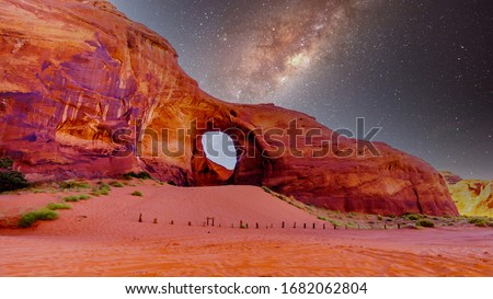Starry Sky behind the Ear of The Wind, a hole in a rock formation in Monument Valley Navajo Tribal Park on the border of Utah and Arizona, United States Royalty-Free Stock Photo #1682062804