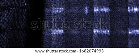 Texture, background, pattern, simple blue fabric with lines. The lines formed by the extraction of the thread,