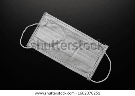 A Medical mask isolated on black background.