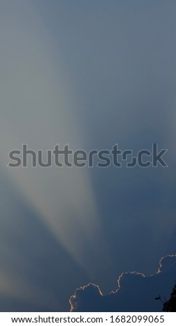 The picture of the sky with sunlight penetrating through the clouds.