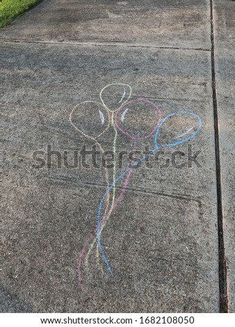 Driveway drawing ballons with crayons chalk