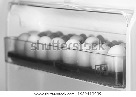 eggs in the fridge in black and white