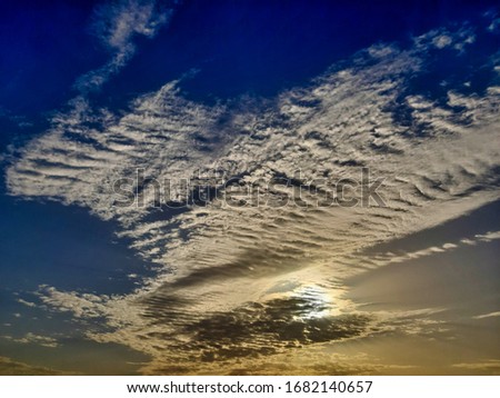 Picture of sky taken in morning. Sun is being covered by clouds
