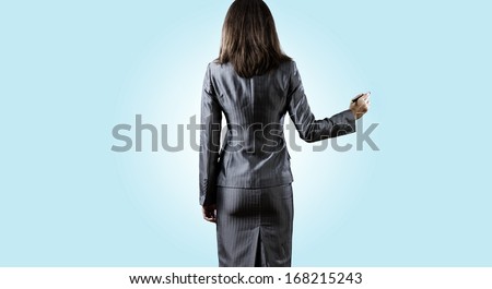 Back view of businesswoman standing against white background