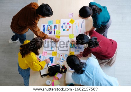 Brainstorm planing creative asian teamwork, Group of asia mobile phone app developer team meeting for ideas about screen display prototype smartphone layout, ux startup small business, top view Royalty-Free Stock Photo #1682157589