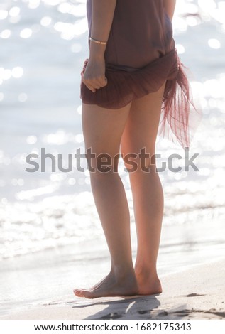 Girl in a dress on the shore of the sea beach. Holiday at the resort