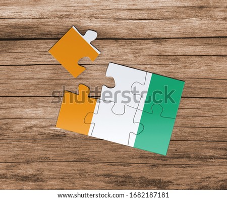 Cote D'Ivoire national flag on jigsaw puzzle. One piece is missing. Danger concept.