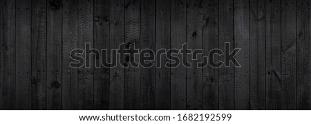 Black wood texture background coming from natural tree. The wooden panel has a beautiful dark pattern that is empty. Royalty-Free Stock Photo #1682192599