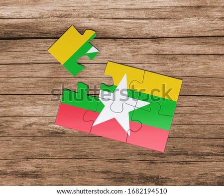 Myanmar national flag on jigsaw puzzle. One piece is missing. Danger concept.