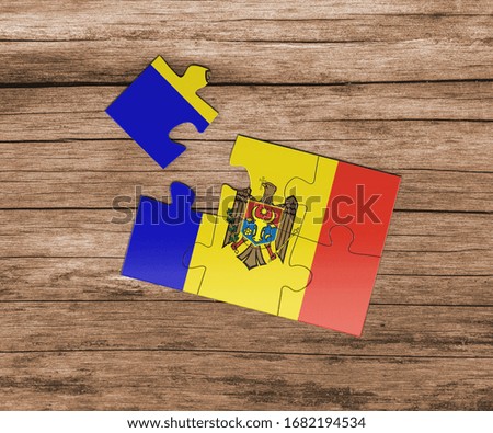 Moldova national flag on jigsaw puzzle. One piece is missing. Danger concept.