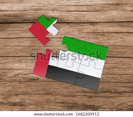 United Arab Emirates national flag on jigsaw puzzle. One piece is missing. Danger concept.