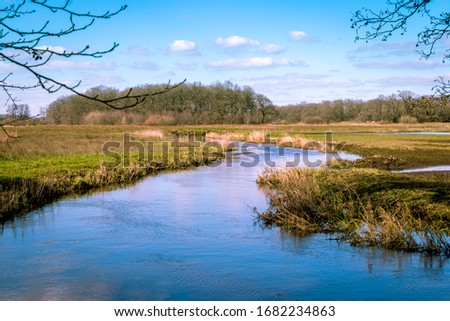 The river Drentse AA in early spring, which winds through the beautiful landscape in the Drenthe national stream and esdorp landscape Royalty-Free Stock Photo #1682234863