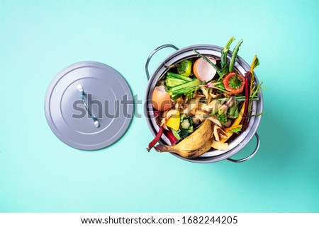 Garbage sorting. Organic food waste from vegetable ready for recycling in compost bin on blue backgrond. Top view. Sustainable and zero waste living. Environmentally responsible behavior, ecology Royalty-Free Stock Photo #1682244205