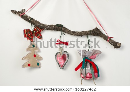 Red Christmas  decorations framed green branch on wood background 