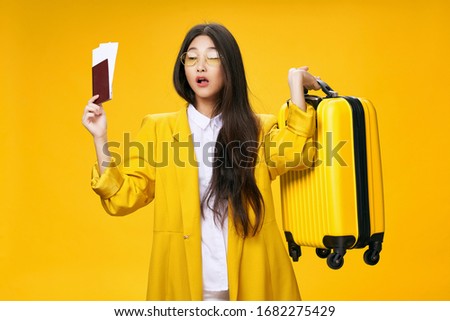 Woman suitcase on wheels passport tickets