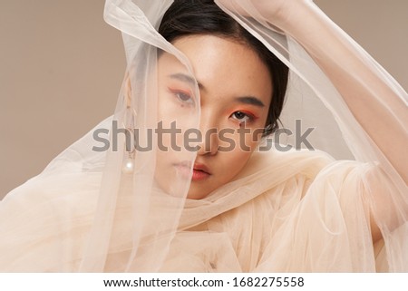 Transparent fabric beautiful woman narrow eyes Asian appearance