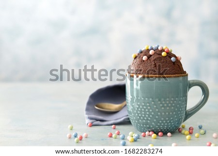 Chocolate mug cake on color background Royalty-Free Stock Photo #1682283274