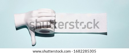 Toilet paper and hand. A concept on the theme of coronavirus.