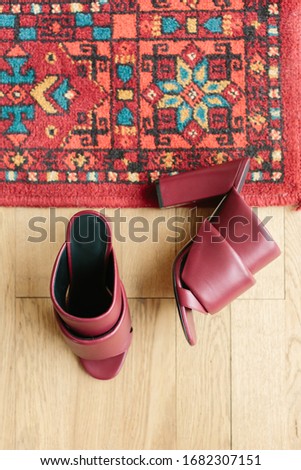 Fashion blog or magazine concept. Fancy burgundy female open toe chunky hills on wooden background. Flat lay, top view minimalism background.