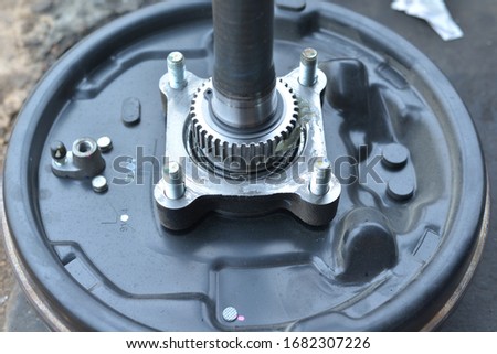 Close-up pinion gear parts with lubricant on blur background of workshop floor.selective focus
