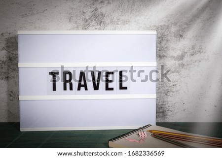 Travel. Business travel, conference, recreation, vacation and family time concept. White lightbox on a wooden table